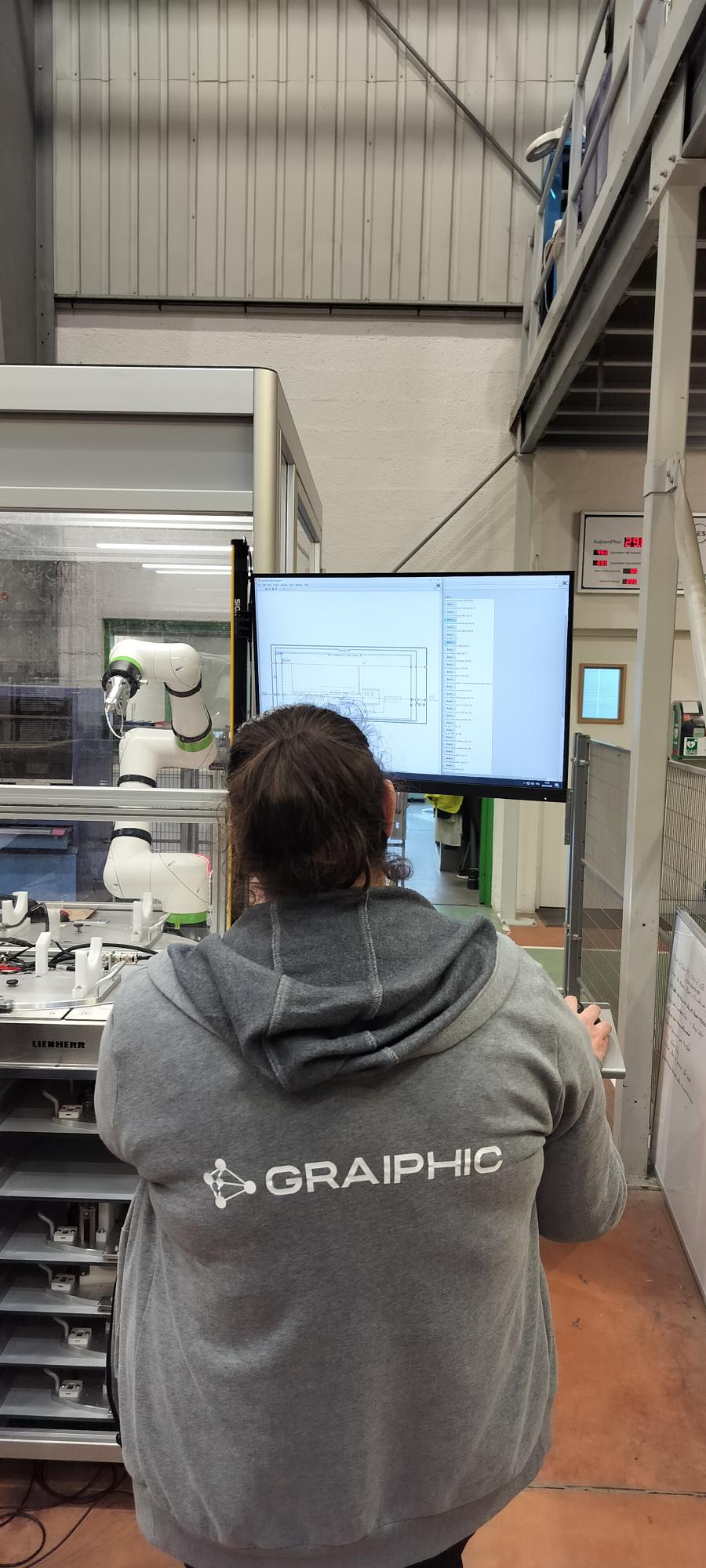 Graiphic engineer at a LabVIEW diagram and robotic cell